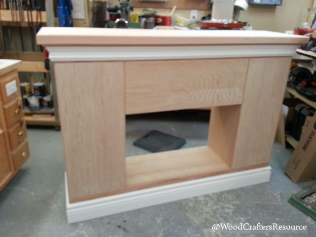 Faux fireplace hardwood edging added to all sides of the plywood doors